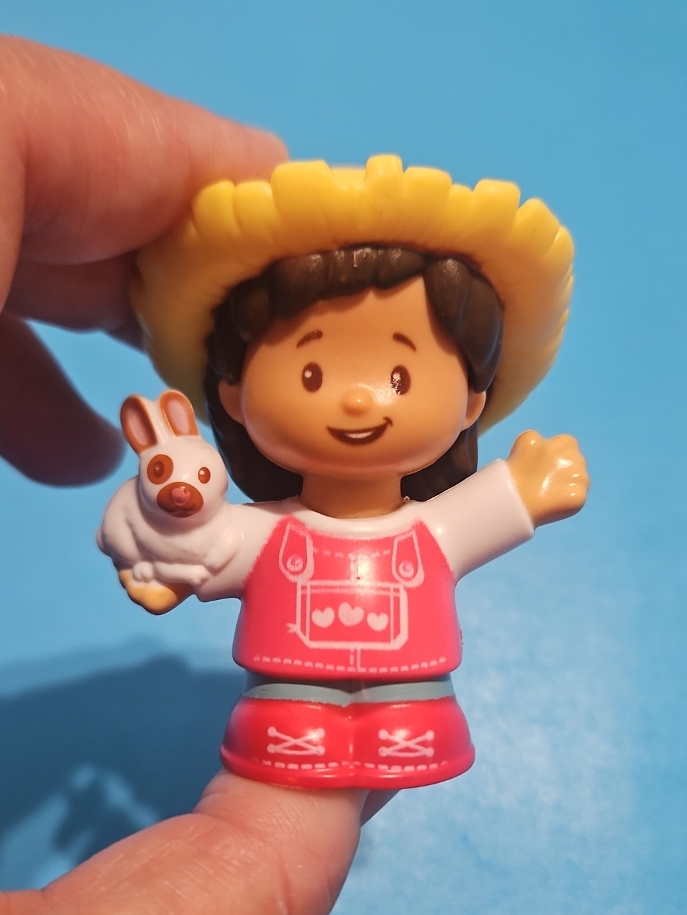 Fisher-Price Little People Farmer Mia figure, often sold with a small bunny.